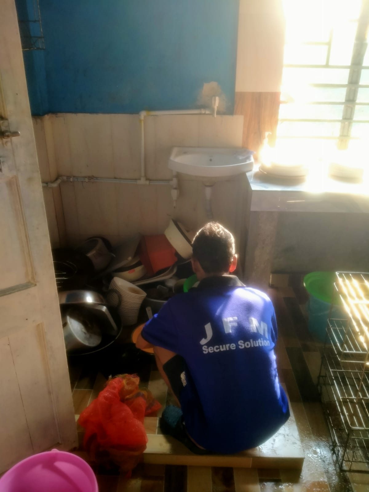 A cleaner at work clearing an interior store room