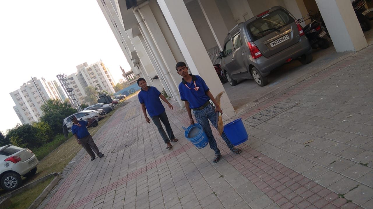Housekeeping staff with equipment at a residential site