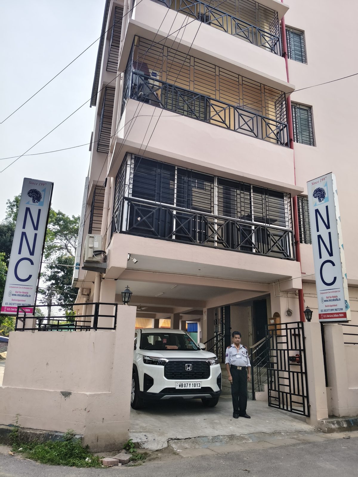 A guard posted at the entrance of a healthcare facility