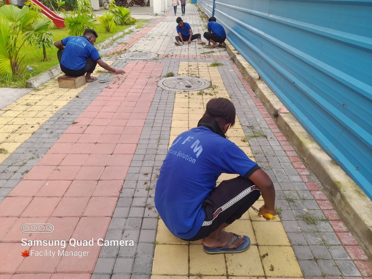 A sweeper cleaning paved external areas at a site