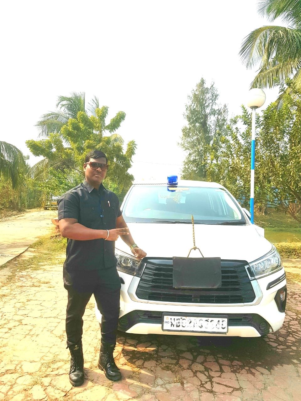 Personal protection officers beside an escort vehicle